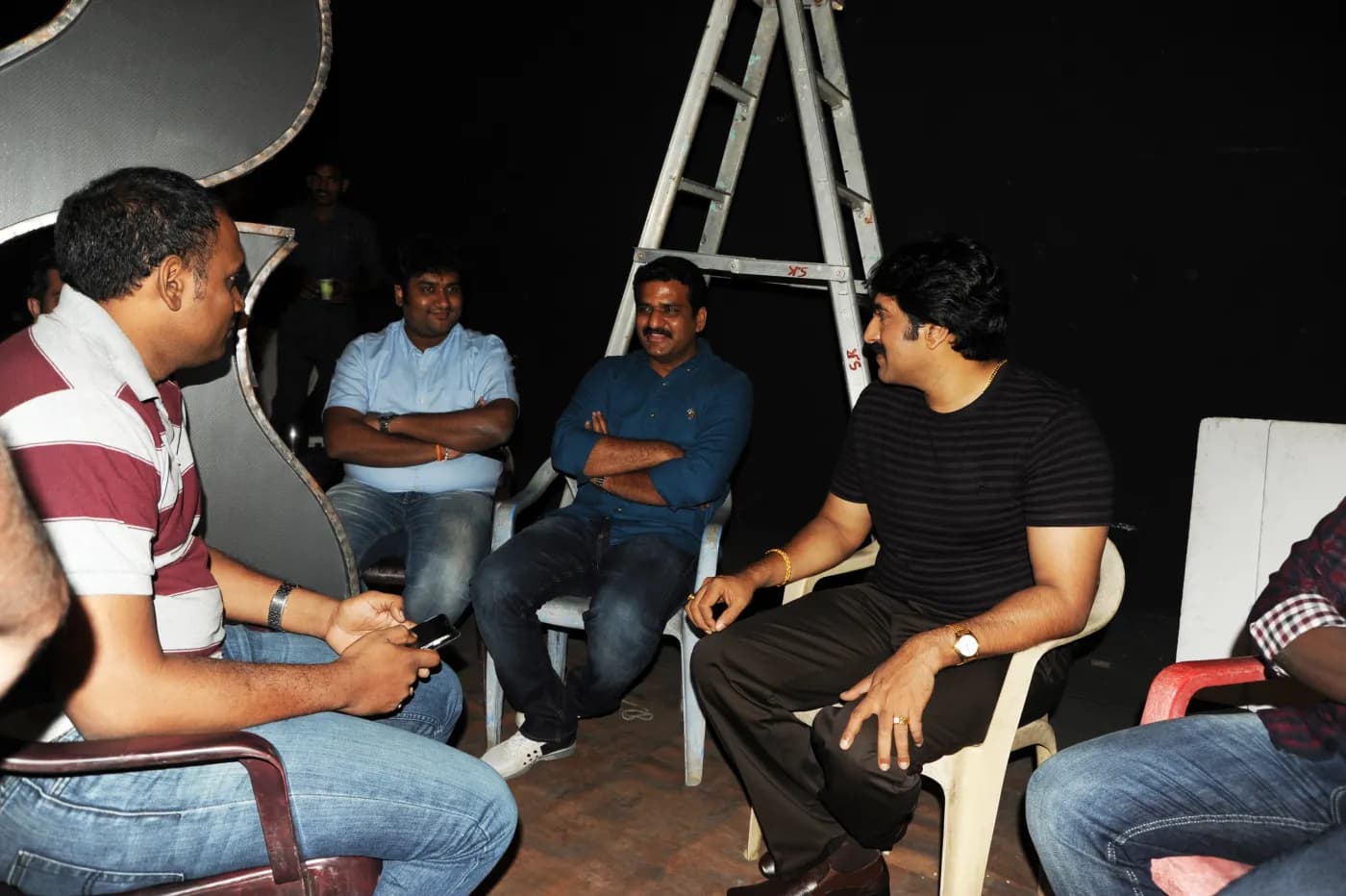 Production crew discussing a scene between takes
