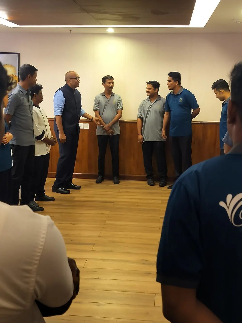 Suresh Ramakrishnan (SRK) coaching frontline staff in a team huddle
