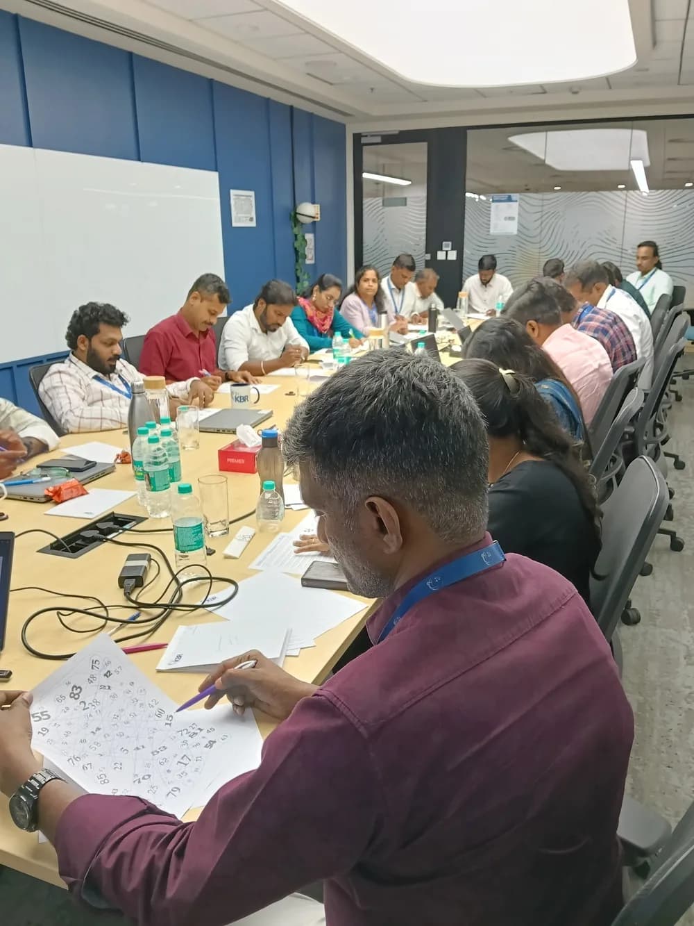 Corporate boardroom training session with employees taking notes