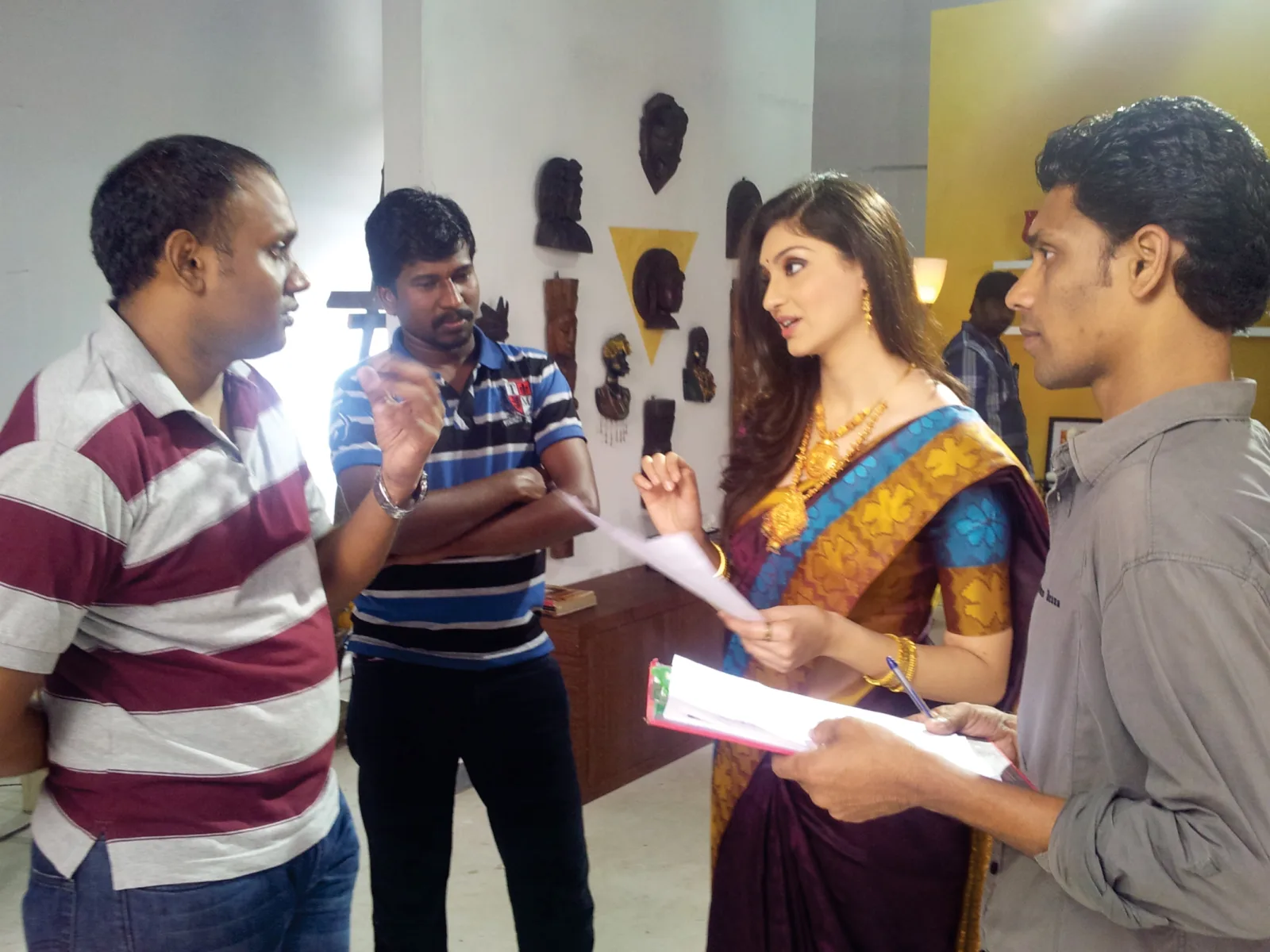 Director briefing a celebrity model on script during a commercial shoot